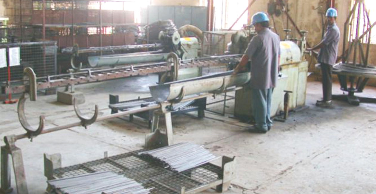 Automatic wire straightening and cutting machine in operation at manufacturing plant