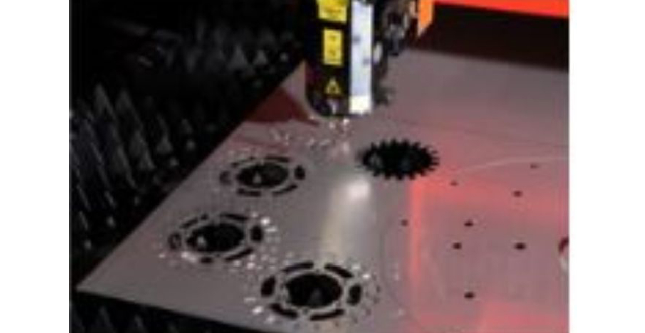 Close-up of CNC laser machine cutting metal sheet with high-power laser beam