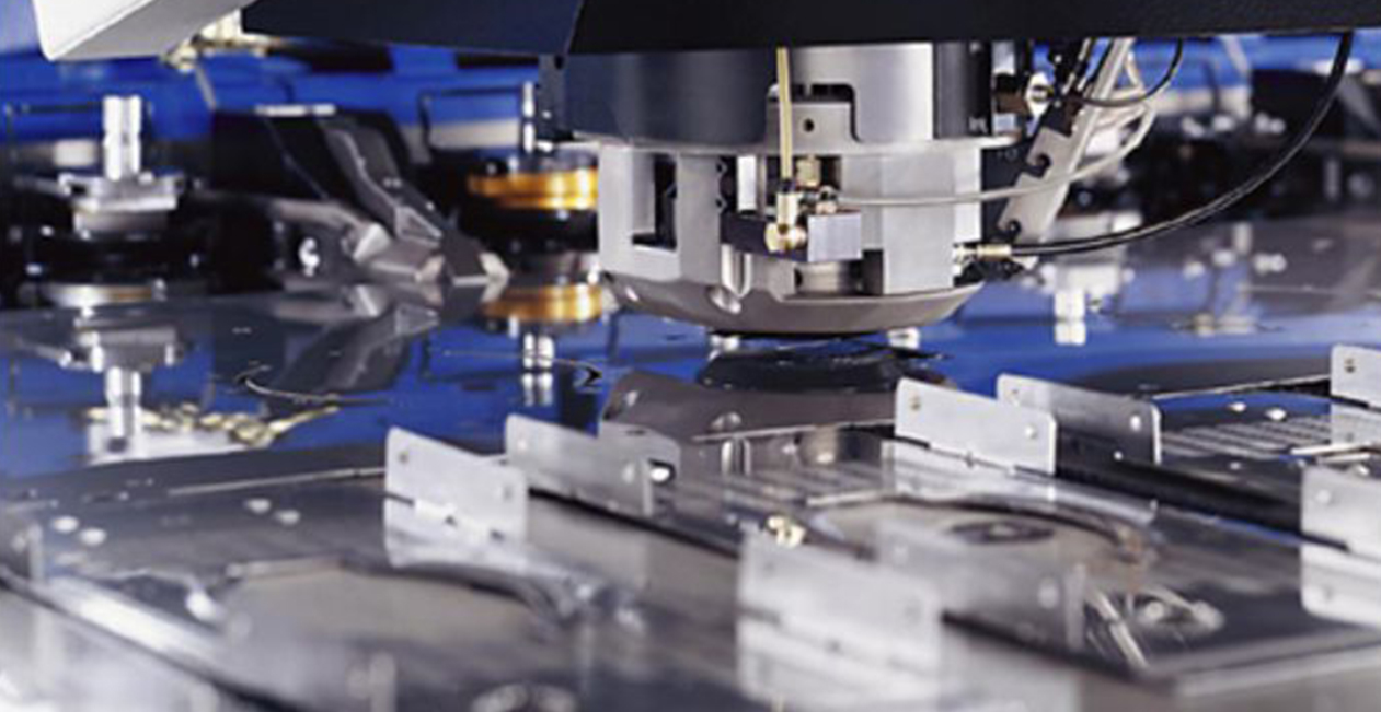 Close-up of CNC punching machine Trumpf Germany showing tool head and sheet metal process