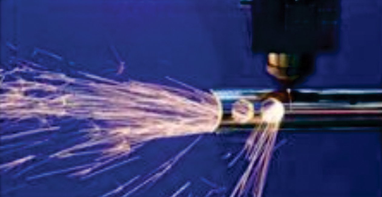 CNC laser cutting process showing bright sparks during high-precision operation