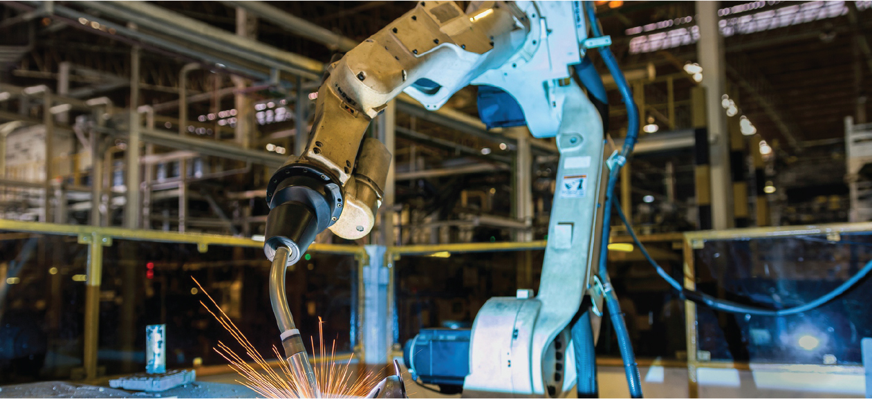 Industrial robotic welding arm performing automated welding in manufacturing facility